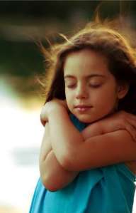 child hugging herself